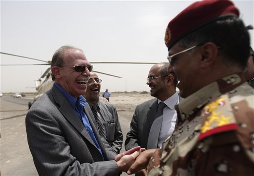In this June 21, 2012, photo, U.S. Ambassador to Yemen Gerald M. Feierstein shakes hands with a Yemeni army officer during a visit to Abyan, Yemen.