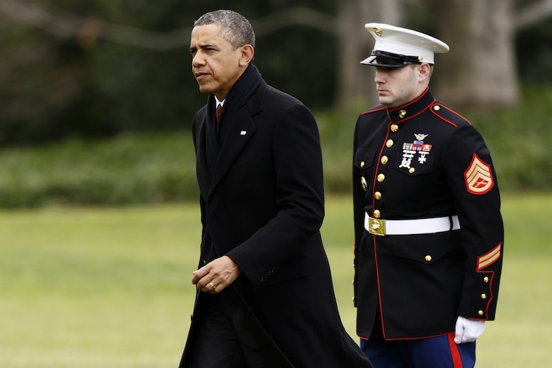 President Barack Obama walks past a Marine honor guard as he steps off the Marine One helicopter and walks on the South Lawn at the White House in Washington, Thursday, Dec. 27, 2012, as he returned early from his Hawaii vacation for meetings on the fiscal cliff. (AP Photo/Charles Dharapak)