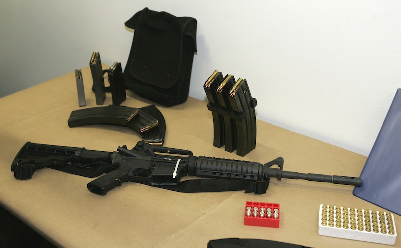 This March 27, 2006 file photo, shows a Bushmaster AR-15 semi-automatic rifle and ammunition on display at the Seattle Police headquarters in Seattle. The maker of the Bushmaster rapid-fire weapon used to kill schoolchildren in Connecticut on Friday, Dec. 14, 2012, was put up for sale on Tuesday, Dec. 18, 2012, as investors soured on the gun business. (AP Photo/Ted S. Warren)