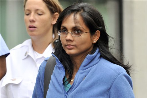 In this Oct. 10, 2012, photo, Annie Dookhan leaves a Boston courthouse escorted by court officers. Dookhan, a Massachusetts chemist is accused of deliberately faking test results on drug samples in criminal cases.