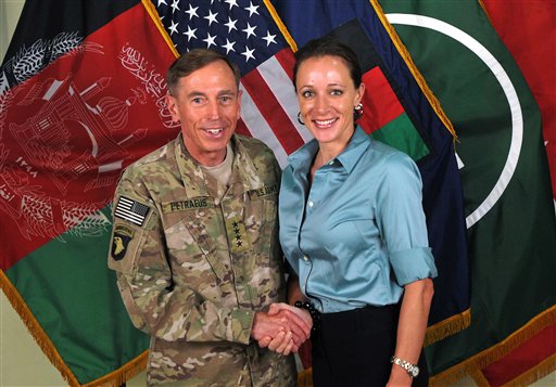 This July 13, 2011, photo, shows former Gen. David Petraeus shaking hands with Paula Broadwell, co-author of "All In: The Education of General David Petraeus."