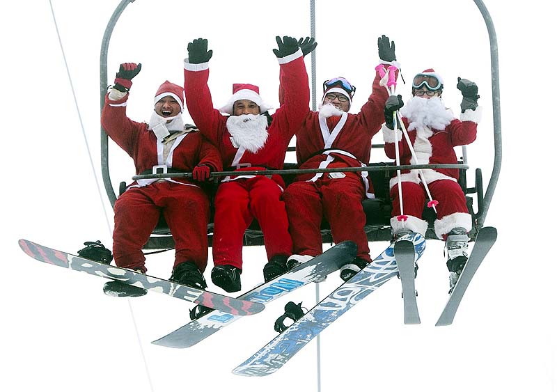 A group of Santas ride a chairlift on Sunday at the Sunday River Ski Resort in Newry, Maine. More than 250 skiers and snowboarders participated in the annual Santa Sunday event to raise money to benefit the Bethel Rotary Club's Christmas for Children program.