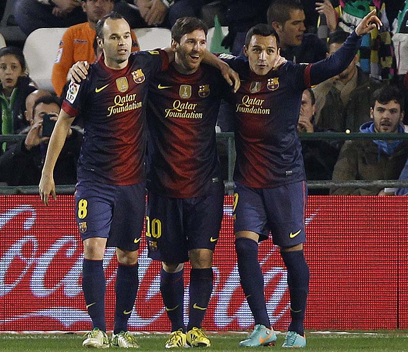 Barcelona's Messi, middle, celebrates with teammates Andres Iniesta, left, and Alexis Sanchez after scoring against Betis during their La Liga soccer match at the Benito Villamarin stadium, in Seville, Spain. XLALIGAX