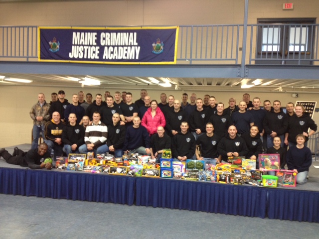 Members of the Maine Criminal Justice Academy's latest graduating class with gifts they gathered to donate to charity.