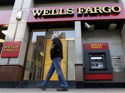 In this Wednesday, Dec. 19, 2012 photo, a man walks past a Wells Fargo location in Philadelphia. U.S. banks are closing the year with the strongest profits since 2006 and fewer failures than at any time since the financial crisis struck in 2008. They're helping support an economy slowed by high unemployment, flat pay, sluggish manufacturing and anxious consumers. (AP Photo/Matt Rourke)