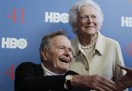 FILE - In a Tuesday, June 12, 2012 file photo, former President George H.W. Bush, and his wife, former first lady Barbara Bush, arrive for the premiere of HBO's new documentary on his life near the family compound in Kennebunkport, Maine. Bush spokesman Jim McGrath said Wednesday, Dec. 26. 2012 that doctors at the Houston hospital where Bush has been treated for a month remain "cautiously optimistic" that he will recover. Still, no discharge date has been set, and McGrath says that doctors are being cautious because at Bush's age "sometimes issues crop up that are beyond anybody's ability to discern or foretell." (AP Photo/Charles Krupa, File)