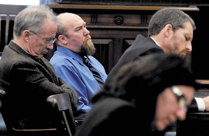 Murder defendant Robert Nelson, center, is flanked by his attorneys before it was announced that he is guilty in the death of Everett L. Cameron in Somerset County Superior Court in Skowhegan on Tuesday, Dec. 18, 2012. State prosecutor Leane Zainea is in the foreground.
