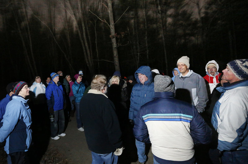 Joe Yuhas (no hat), former University of New England science professor, lectures to more than 40 hikers on the moonlight hike.