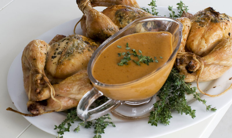 Herb-roasted Cornish game hens with a creamy mustard sauce is a lower-fat but festive choice for a holiday dinner.