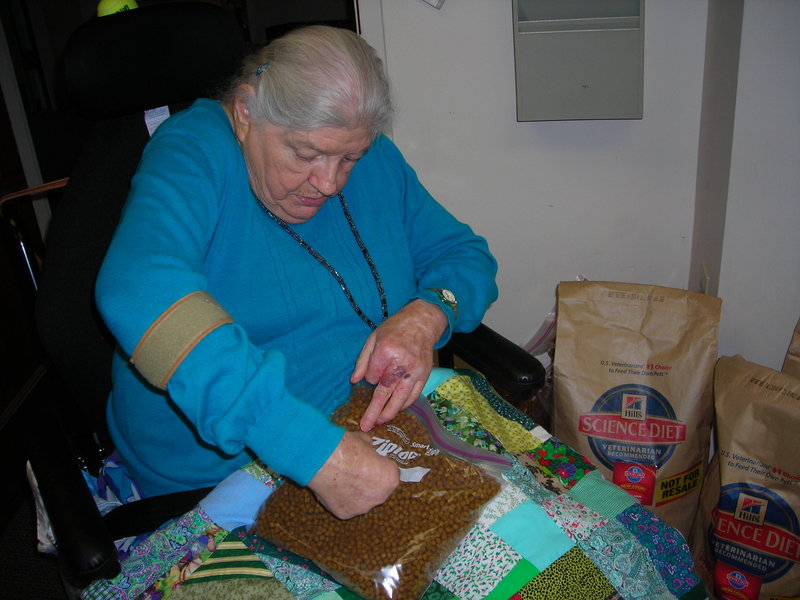 Dottie Carter helps package pet food that will be delivered, along with regular Meals on Wheels dinners, to seniors who have pets. “I enjoy my job (volunteering) to help the animals,” she said.