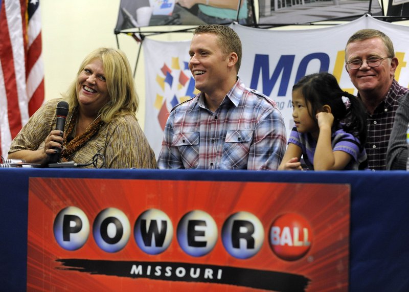 Cindy Hill talks about winning the record Powerball jackpot Friday as, from left, son Jason, daughter Jaiden and husband Mark look on during a news conference at the North Platte High School in Dearborn, Mo.
