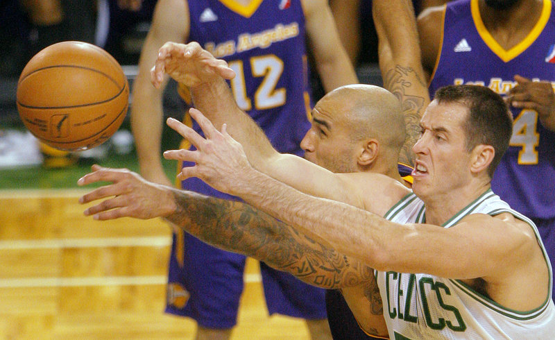 Maine’s Chris Ayers, right, battles Robert Sacre of the D-Fenders for a loose ball during Friday nights 97-94 loss to Los Angeles. The Red Claws fell to 2-1 on the year.