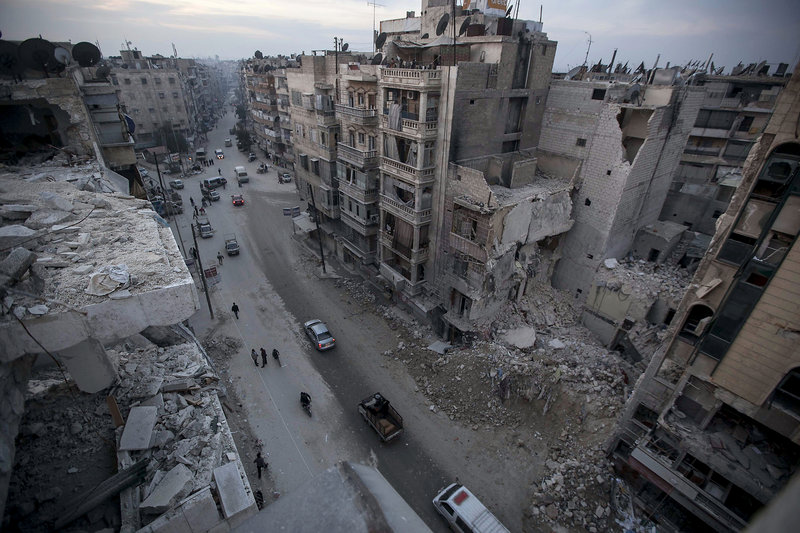 Destroyed buildings, including the Dar Al-Shifa hospital, are seen on a Sa’ar street Thursday after airstrikes targeted the area in Aleppo, Syria.