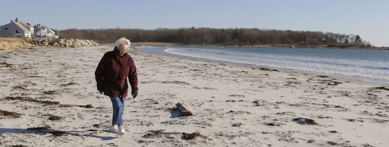 Joan Junker walks along Goose Rocks Beach in Kennebunkport on Thursday. Junker has spent every summer since 1930 at Goose Rocks and was surprised when some of her oceanfront neighbors filed a lawsuit, claiming they owned the beach.