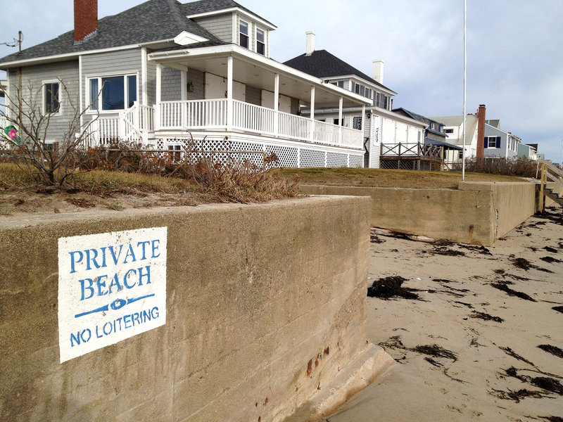 A sign posted on a seawall at Moody Beach proclaims, “Private Beach. No Loitering.” Property owners there won a landmark 1989 case affirming private ownership of the shore straight to the low-water mark. Unlike most other states, Maine’s beaches and other intertidal property are not owned by the state, though recent court cases have increased public access rights.