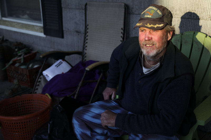 John Frawley sits on the porch of his house, which was damaged during Superstorm Sandy, on the Rockaway Peninsula in New York on Thursday.