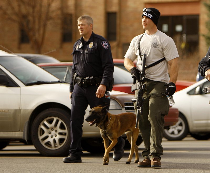 Casper police leave the Wold Physical Science Building at Casper College on Friday in Casper, Wyo., where a man killed a teacher and himself in front of college students.