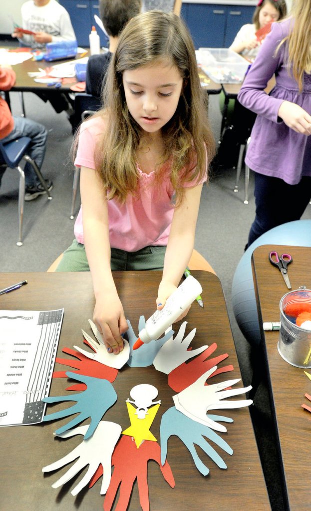 Hannah Morrison, a third-grader at Jameson School makes decorations for veterans as part of Hugs of Love.