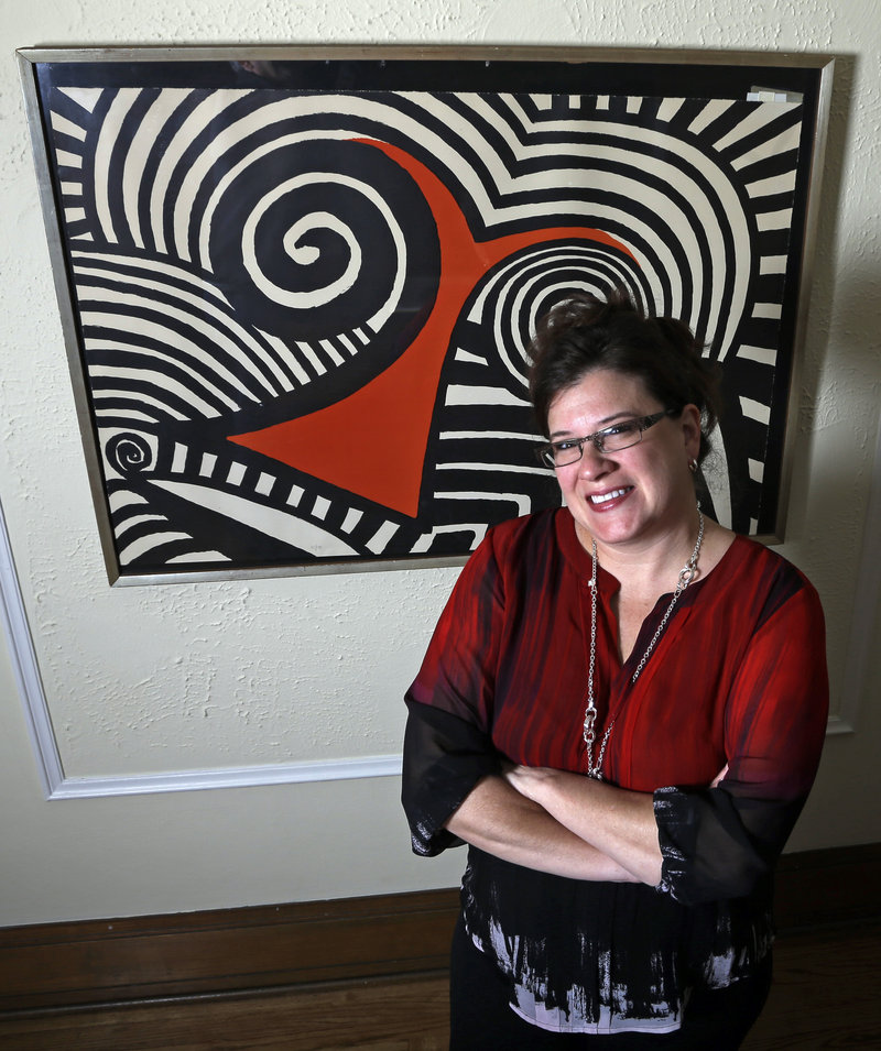 Karen Mallet stands in front of the Alexander Calder print she bought for $12.34 at a Goodwill thrift store in Milwaukee. It turned out to be worth $9,000.