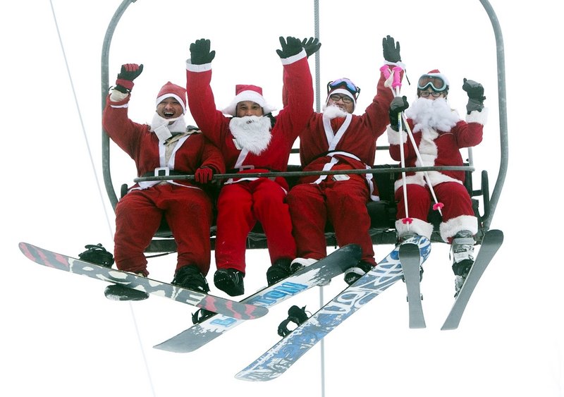 Four Santas ride a chairlift at the Sunday River Ski Resort in Newry on Sunday. More than 250 skiers and snowboarders participated in the annual Santa Sunday event to raise money to benefit the Bethel Rotary Club’s Christmas for Children program.
