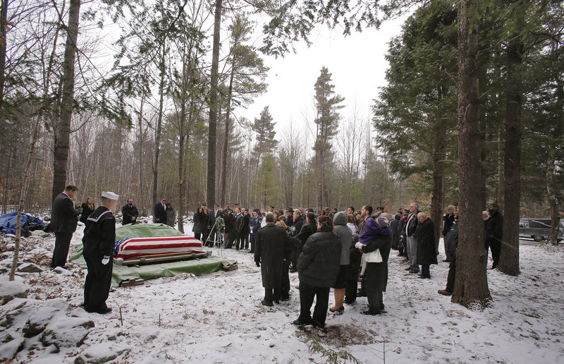 Pastor Mark Kraines, left, leads a burial service for Edward Lovely on Saturday, Dec. 1, 2012. Lovely was buried on the property of his son Don after being diagnosed with lung cancer in October and expressing his desire to be buried on Don's property.