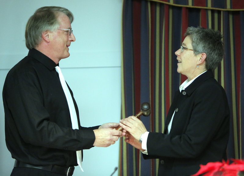 New Mayor Tom Blake presents the outgoing mayor, Patti Smith, with a gavel on Monday in South Portland.