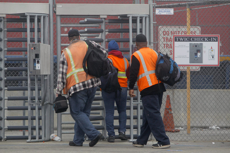 Workers returned Wednesday to the ports in Long Beach and Los Angeles, after settlement of a strike that had crippled the container port complex for eight days.