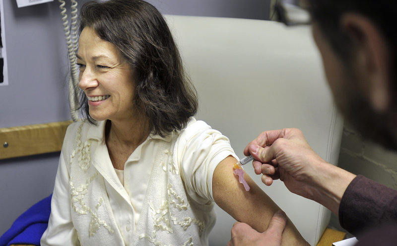 Joanne Yarnold of South Portland receives a flu shot from Bob Barrett, a registered nurse at the India Street Clinic, on Wednesdaym Dec. 5, 2012.