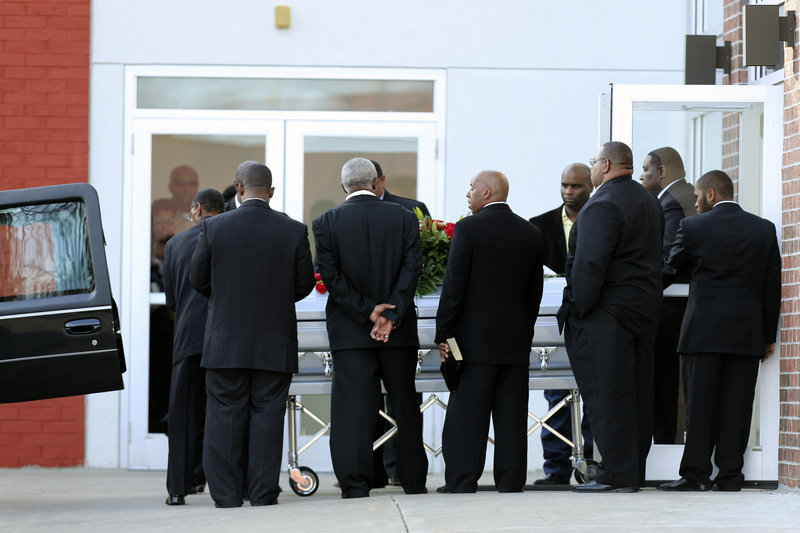A coffin with the body of Chiefs linebacker Jovan Belcher is placed in a hearse after a service at the Landmark International Deliverance and Worship Center Wednesday in Kansas City, Mo.