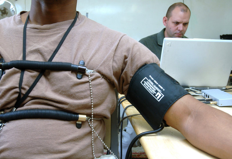 U.S. Air Force Staff Sgt. Jason Arnold, 407th Expeditionary Communications Squadron, acts as an examinee for an Office of Special Investigations polygraph examiner.