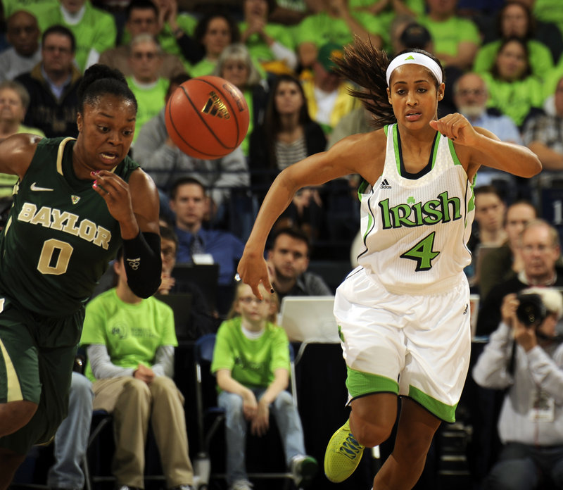 Odyssey Sims, left, of Baylor and Notre Dame’s Skylar Diggins chase a loose ball in Wednesday’s big matchup in South Bend, Ind. No. 3 Baylor beat No. 5 Notre Dame, 73-61.