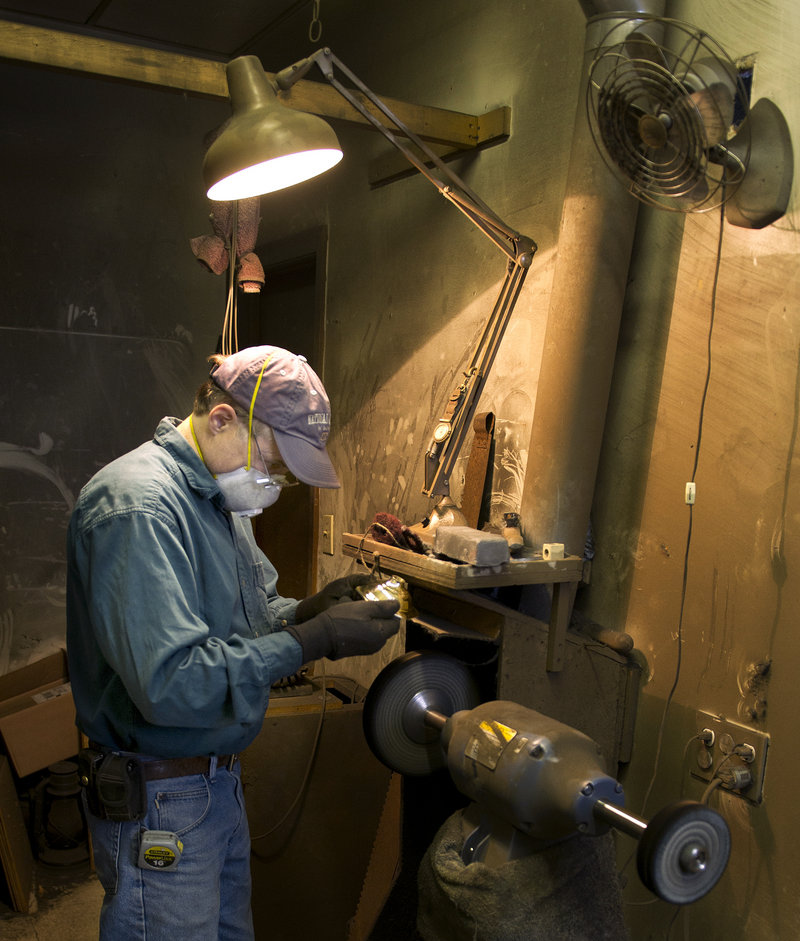 Mike Gutgsell owns The Polishing Shop, which adjoins Allen’s lamp-repair shop in South Portland. He’s shown here at his work station, using a polishing machine to restore a brass candlestick. The shops cater to a mostly local clientele, but have attracted customers from New York and California.