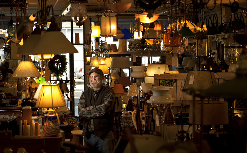 Brian Allen, owner of The Lamp Repair Shop in South Portland, is surrounded by lamps – some are repair jobs, some are his okwn creations. Allen started the business in 1986, and moved it to Knightville in 2002.