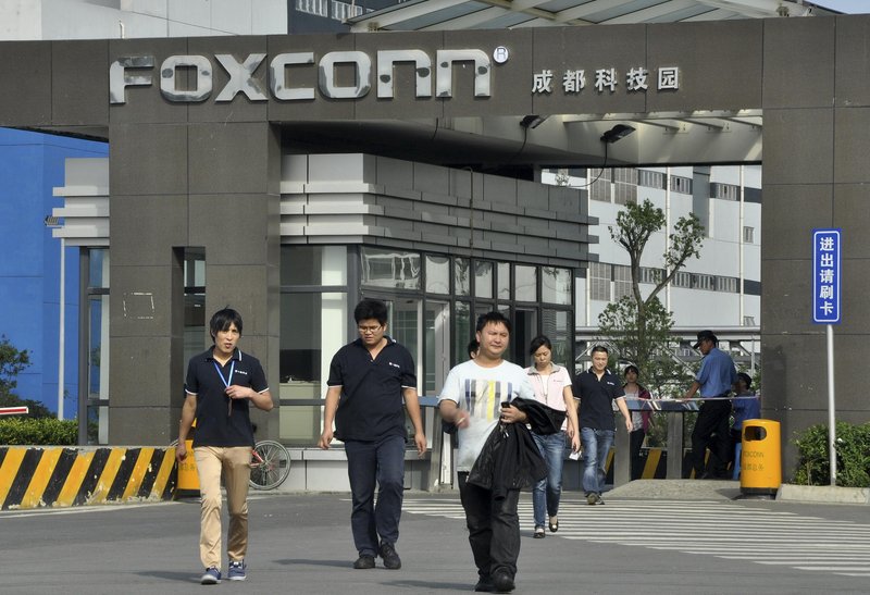 Workers leave the Foxconn factory in Chengdu, China, where Apple products are assembled. Criticism of Foxconn led to an increase in pay for its workers – echoing a trend of rapidly rising wages in China generally.