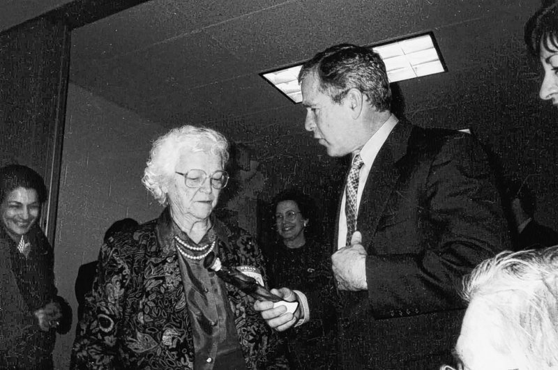 Then-President George W. Bush presents a gift of recognition to Lillian Peterson for her tireless dedication to the Salvation Army at a luncheon on March 23, 2001. Ms. Peterson has died at the age of 94.