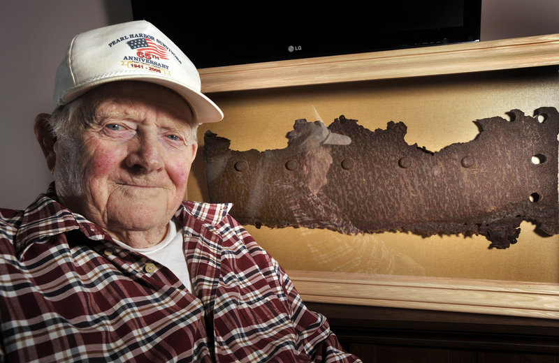 Bert Davis, a veteran who lived through attack on Pearl Harbor, with a rusted piece of steel from the USS Arizona, which will be unveiled Friday in Maine on the 71st anniversary of the attack.