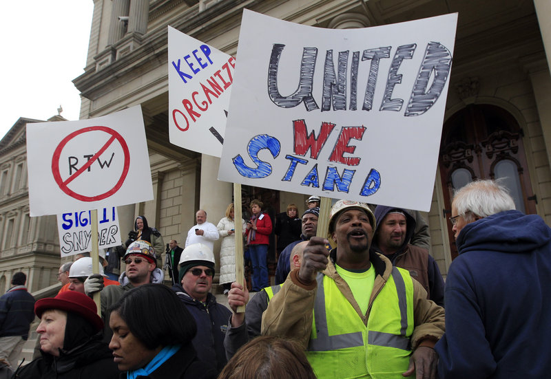 Union workers rally outside the capitol in Lansing, Mich., Thursday as Republicans passed right-to-work legislation.