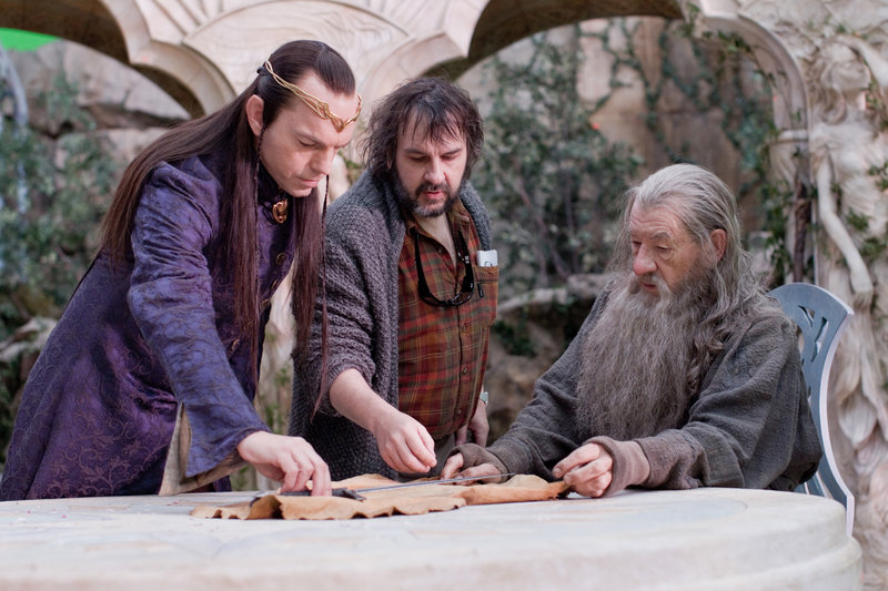 Hugo Weaving as the elven leader Elrond, left, director Peter Jackson and Ian McKellen as Gandalf the Grey on the set of the fantasy adventure, “The Hobbit: An Unexpected Journey.”