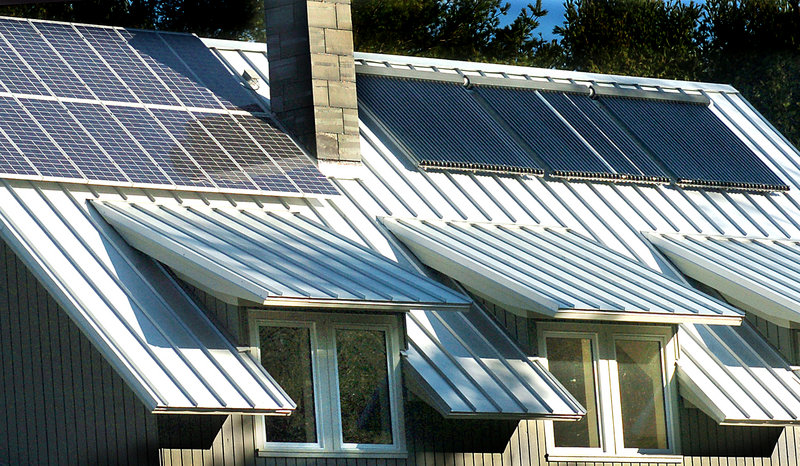 Solar panels and solar hot water panels cover the roof of a Freeport residence. A letter writer who recently installed a grid-tied solar power system says grid disruptions too small for utility equipment to measure can trigger shutdowns in such a system, potentially on a daily basis.