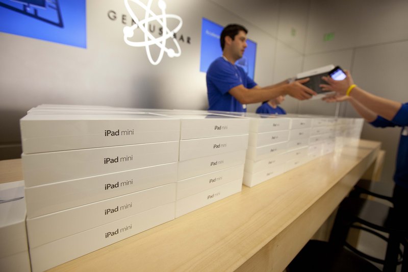 An Apple specialist hands over the new Apple iPad mini to a customer at an Apple store in San Francisco. The iPad Mini sells for $329, which helps Apple protect its profit margins and preserve its reputation for selling top-of-the-line products that merit prices a notch above the competition. Nevertheless, the iPad mini is undoubtedly diverting some sales from full-sized iPads, which sell at prices ranging from $399 to $829. That is one of the reasons BGC Financial analyst Colin Gillis expects the iPad’s average selling price to fall by about $50 in the current quarter.