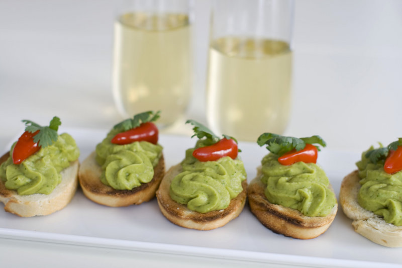 Associated Press food editor J.M. Hirsch suggests spring pea guacamole served on crackers with a Christmas sangria.