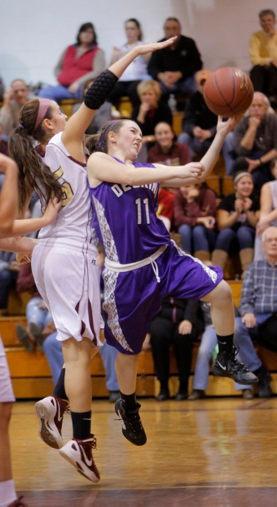Delaney Coyne of Deering lays the ball up Friday night while eluding a block attempt by Emily Richard of Thornton Academy in their SMAA opener. The shot went in, but moments after the buzzer ended the first quarter. Deering emerged with a 38-35 victory at Saco.
