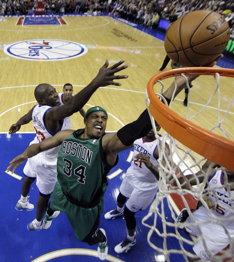 Paul Pierce of the Boston Celtics drives past Jason Richardson of the Philadelphia 76ers for a basket Friday night in the first half of the Sixers’ 95-94 overtime victory.