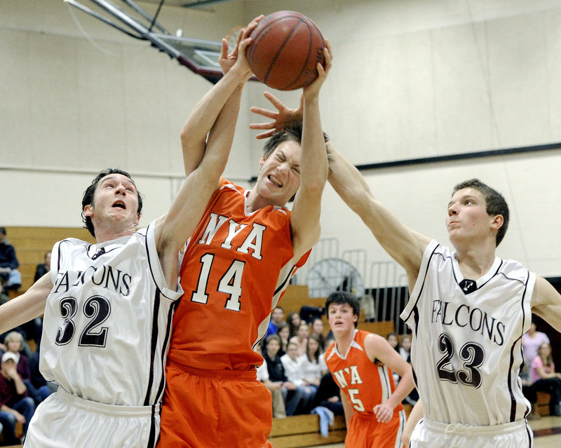 Mike McIntosh of NYA pulls down a rebound Saturday between Connor Dietrich, left, and Jack Davenport of Freeport. Freeport won, 51-36.