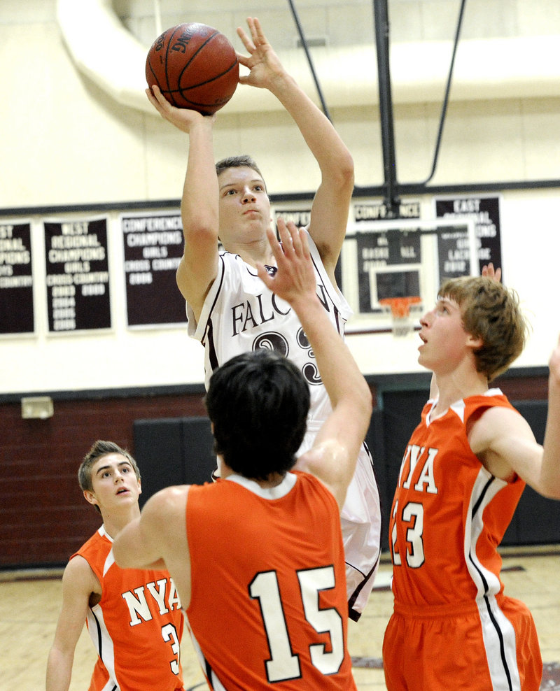Jack Davenport, who scored 13 points Saturday for Freeport, takes a shot over Burke Paxton, foreground, and Jackson Cohan-Smith, right, of North Yarmouth Academy during Freeport’s 51-36 victory.