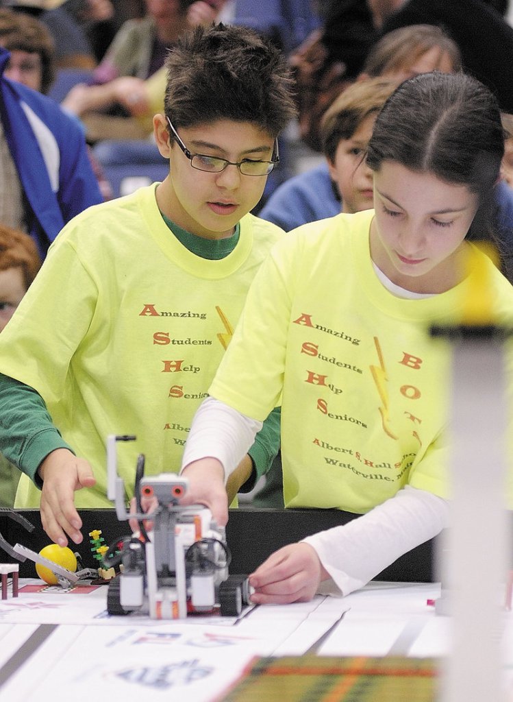 Alex Millones, left, and Abigail Bloom set up their team’s robot to compete Saturday at the Maine FIRST Lego League Championship at the Augusta Civic Center.