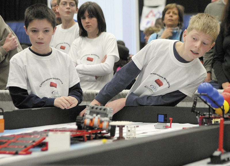 Preston Moody, left, and Isaac Lawrence watch their team’s robot compete Saturday at the Maine FIRST Lego League Championship in Augusta.