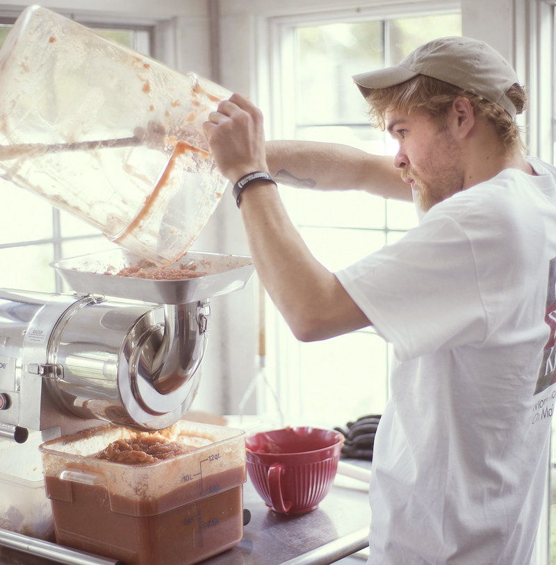 Kitchen apprentice Damien Brooks processes applesauce at Cheryl Wixson’s Kitchen.