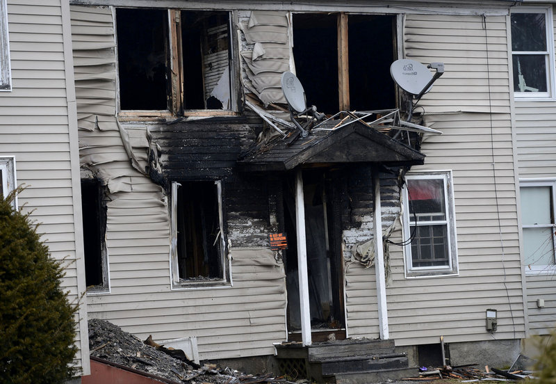 This Monday, Dec. 10 photo shows a three-unit Windham apartment building on Gray Road that was damaged by fire. The owner of the building is now suspected of setting the fire and then tying himself up to make it look like a mob hit.
