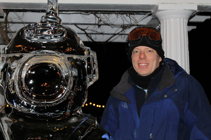 Ice sculptor Ed Jarrett with his deep-sea diver, one of more than a dozen works he created for the third annual event.